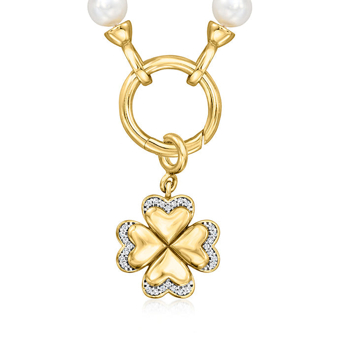 Gold four-leaf clover charm with heart-shaped center and sparkling stone border