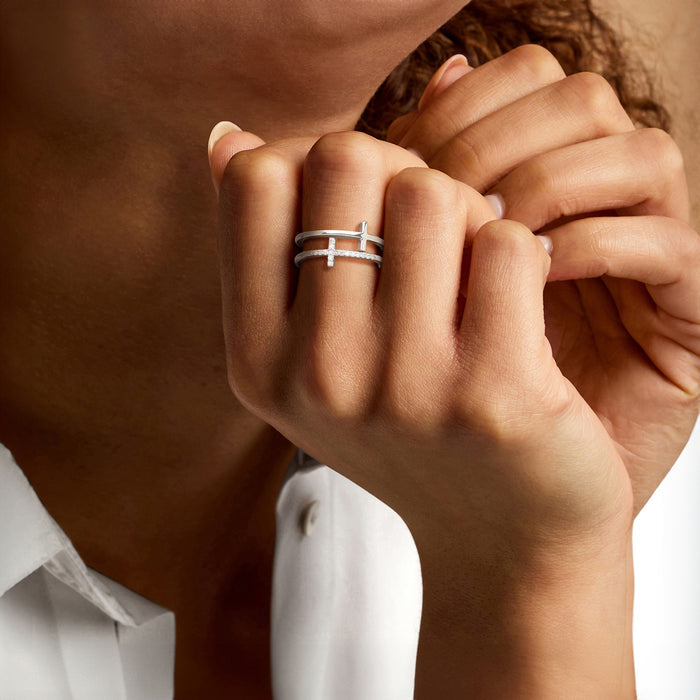 Sterling silver two-row cross ring with diamond accents on a hand