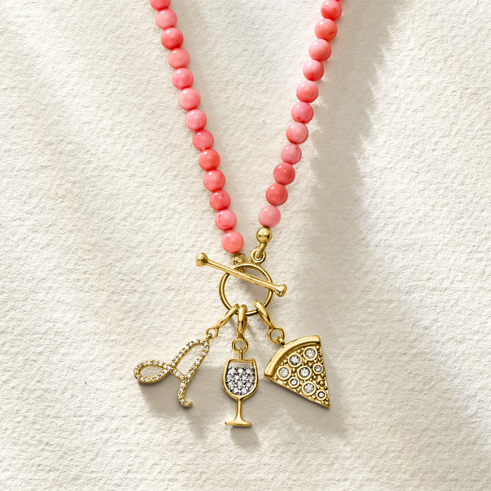 Wine glass diamond charm dangling from coral beaded necklace