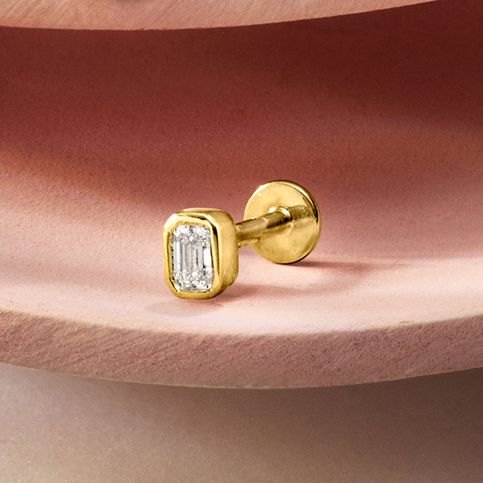 14kt yellow gold emerald-cut diamond stud earring, flat-back on ear