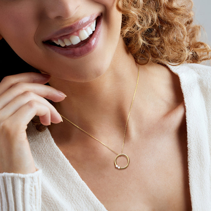 18kt gold over sterling necklace with circular pendant and three lab-grown diamonds.