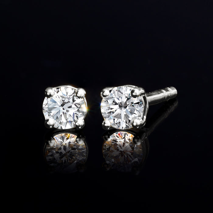 Round diamond stud earrings, four-prong sterling silver setting with post backs