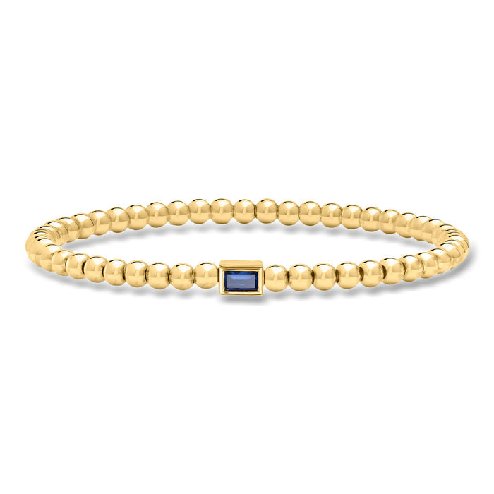 Gold bead stretch bracelet with blue square gemstone centerpiece