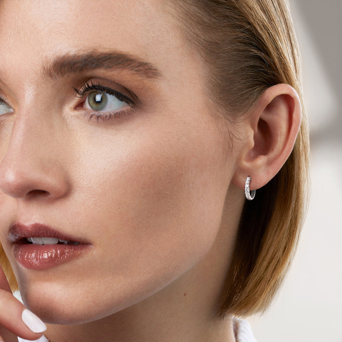 Lab-grown diamond hoop earrings in sterling silver on ear, close-up profile