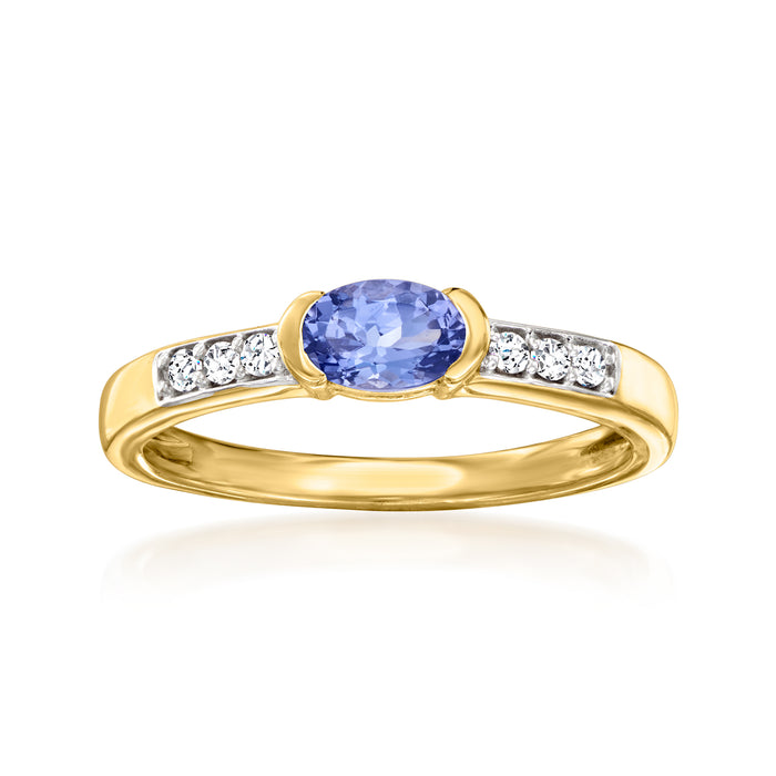 Gold ring with oval blue center stone and white zircon side accents