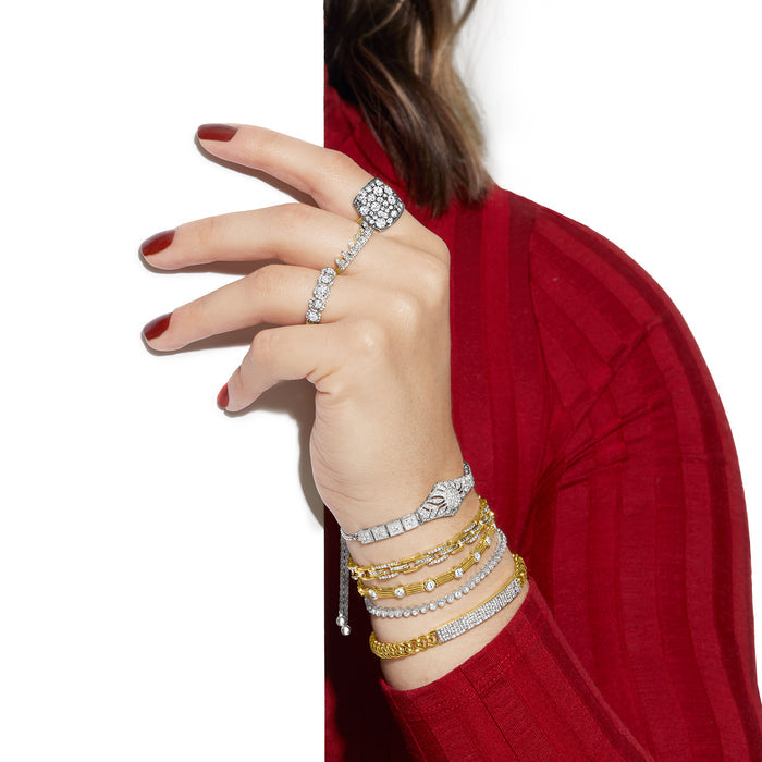 Sterling silver diamond floral openwork bolo bracelet on a wrist