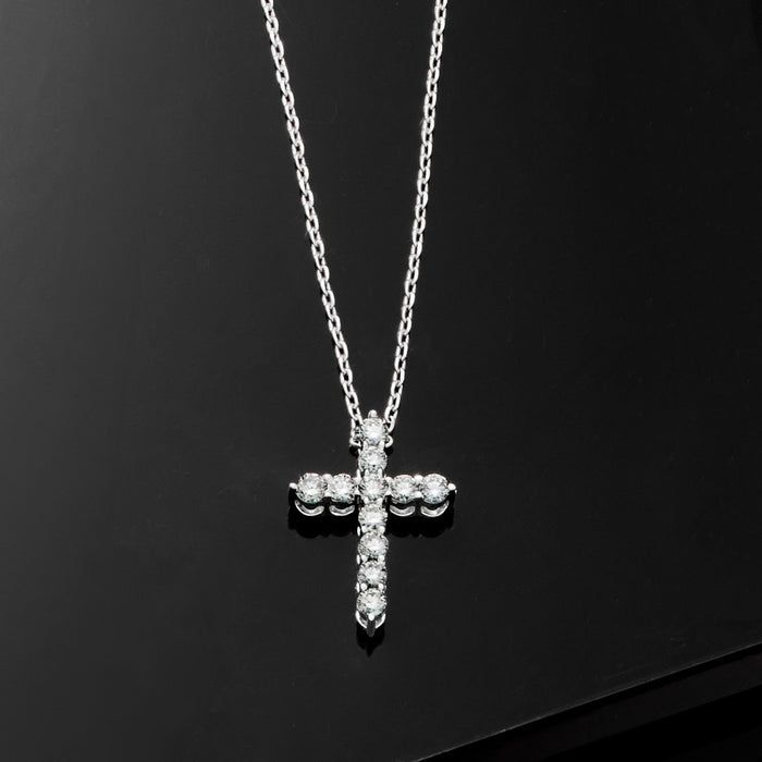 Sterling silver diamond cross pendant necklace with teardrop and round stone details