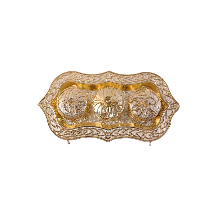 Studio shot of the golden Kankavati on a white background.