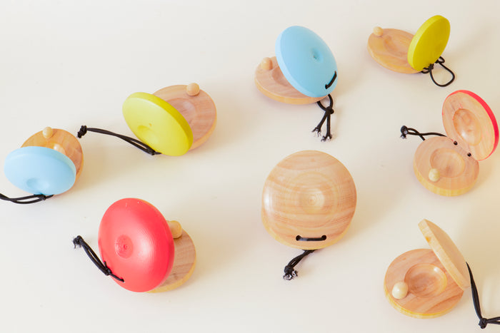 Colorful wooden toys resembling acorns on a white background